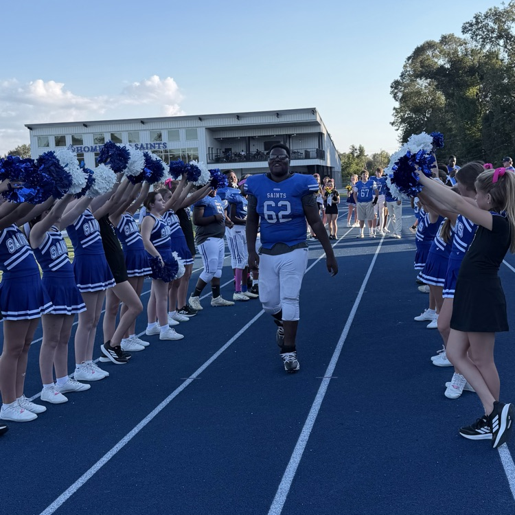 8th grade student athlete walks through cheer tunnel