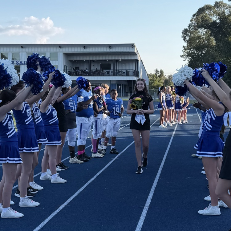 8th grade student athlete walks through cheer tunnel