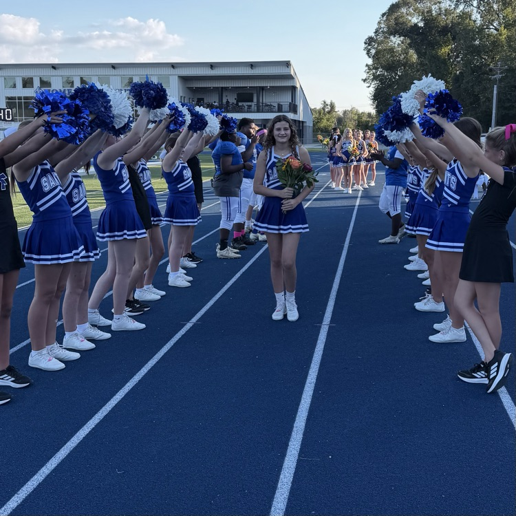 8th grade student athlete walks through cheer tunnel