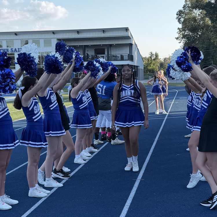 8th grade student athlete walks through cheer tunnel