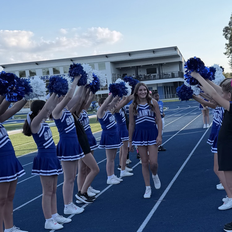 8th grade student athlete walks through cheer tunnel
