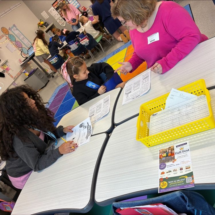 middle school student works with elementary students