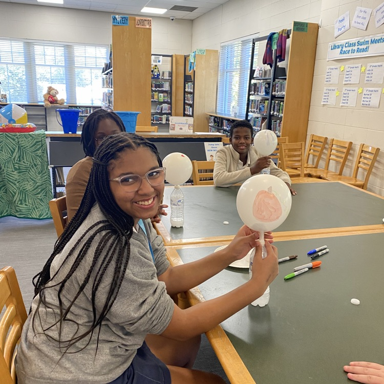 Students play a game with balloons