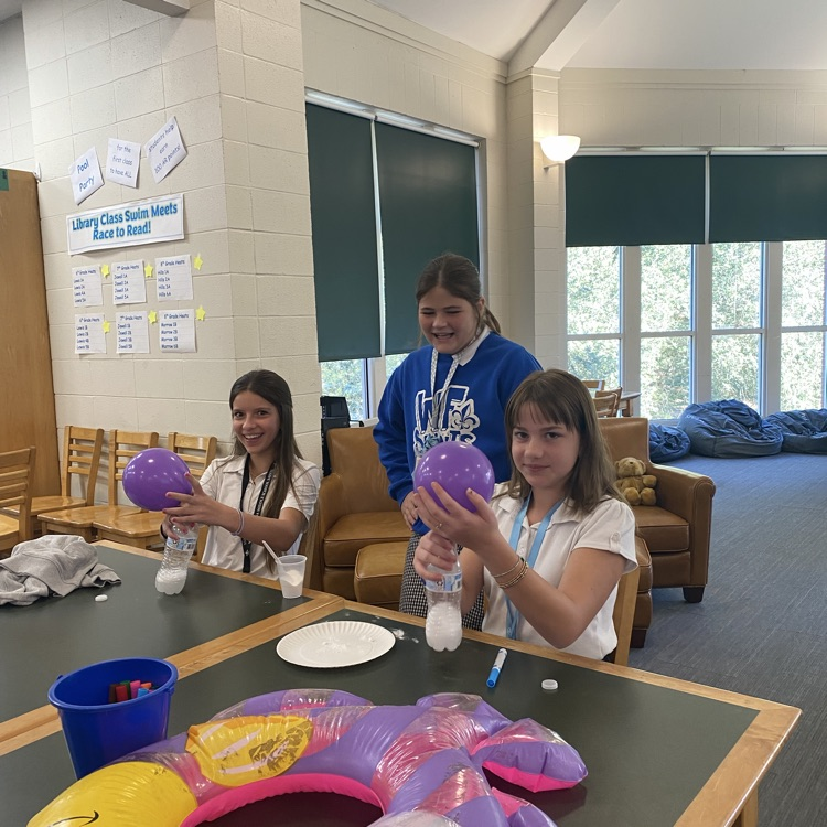 Students play a game with balloons