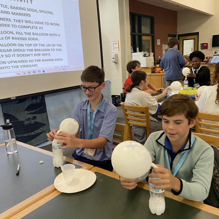 Students play a game with balloons