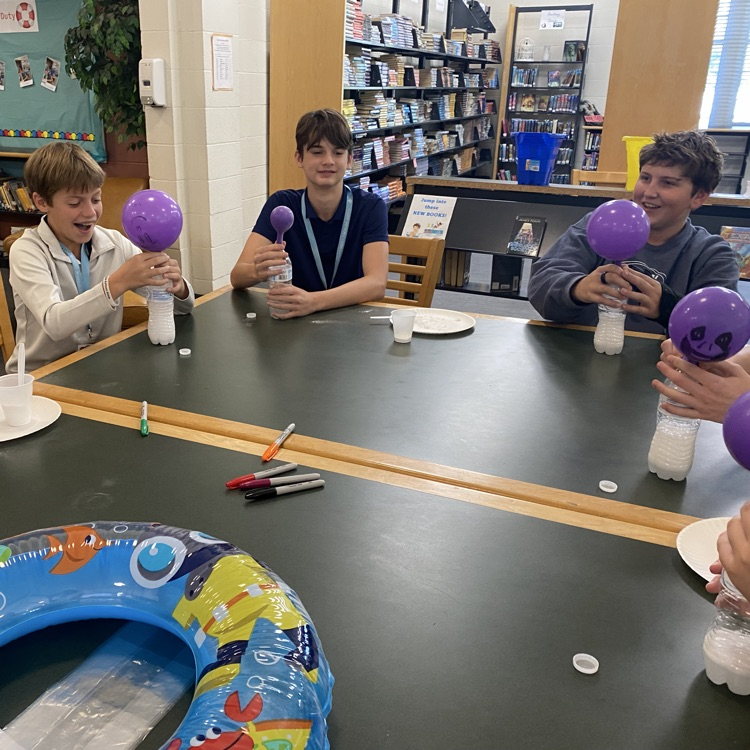 Students play a game with balloons