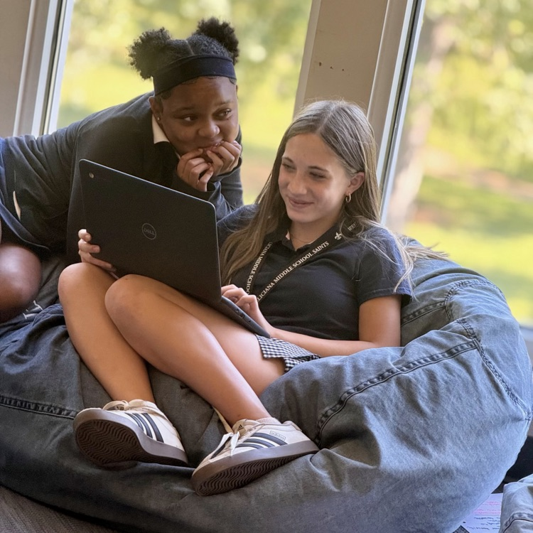 students collaborate on computer 