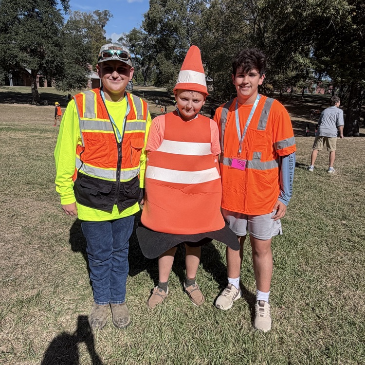 Students dress as construction workers and traffics cones in celebration of pit crew day for homecoming week
