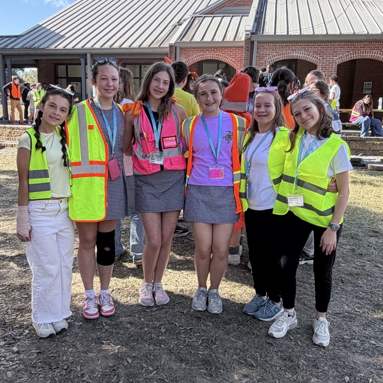 Students dress as construction workers and traffics cones in celebration of pit crew day for homecoming week
