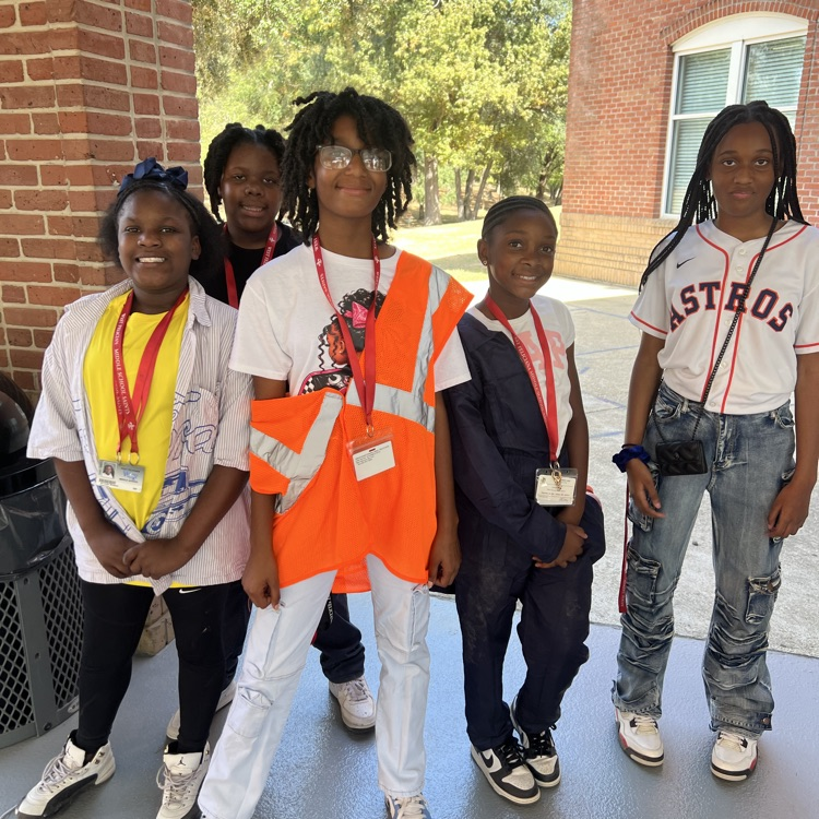 Students dress as construction workers and traffics cones in celebration of pit crew day for homecoming week