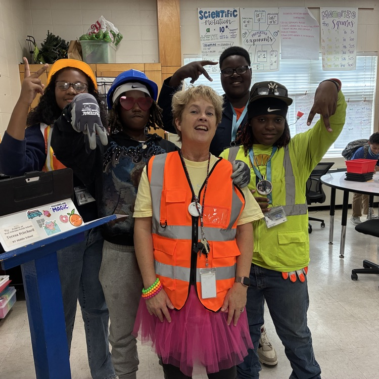 Students dress as construction workers and traffics cones in celebration of pit crew day for homecoming week