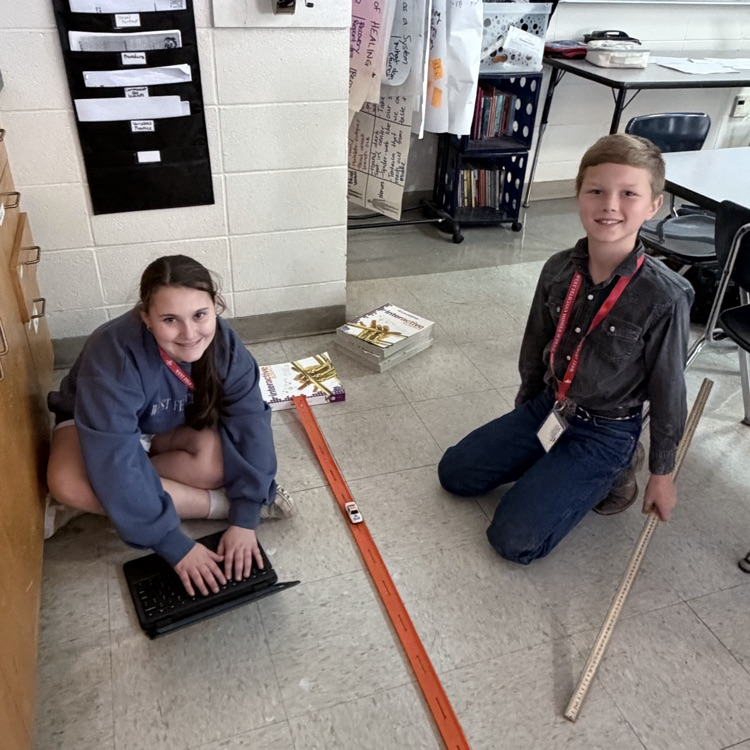 students conduct an experiment with matchbox cars