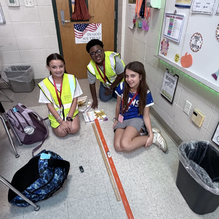 students conduct an experiment with matchbox cars