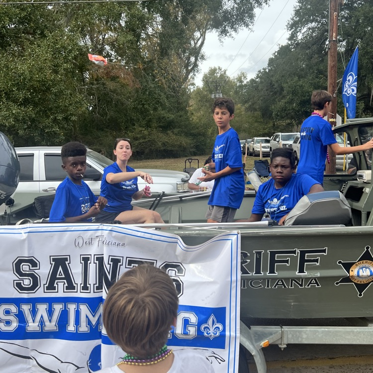 Students and staff ride in parade
