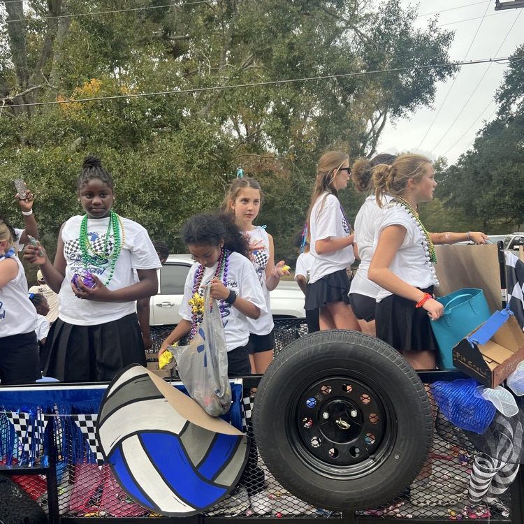 Students and staff ride in parade