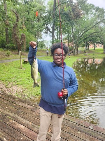 student in fishing club shows off catch