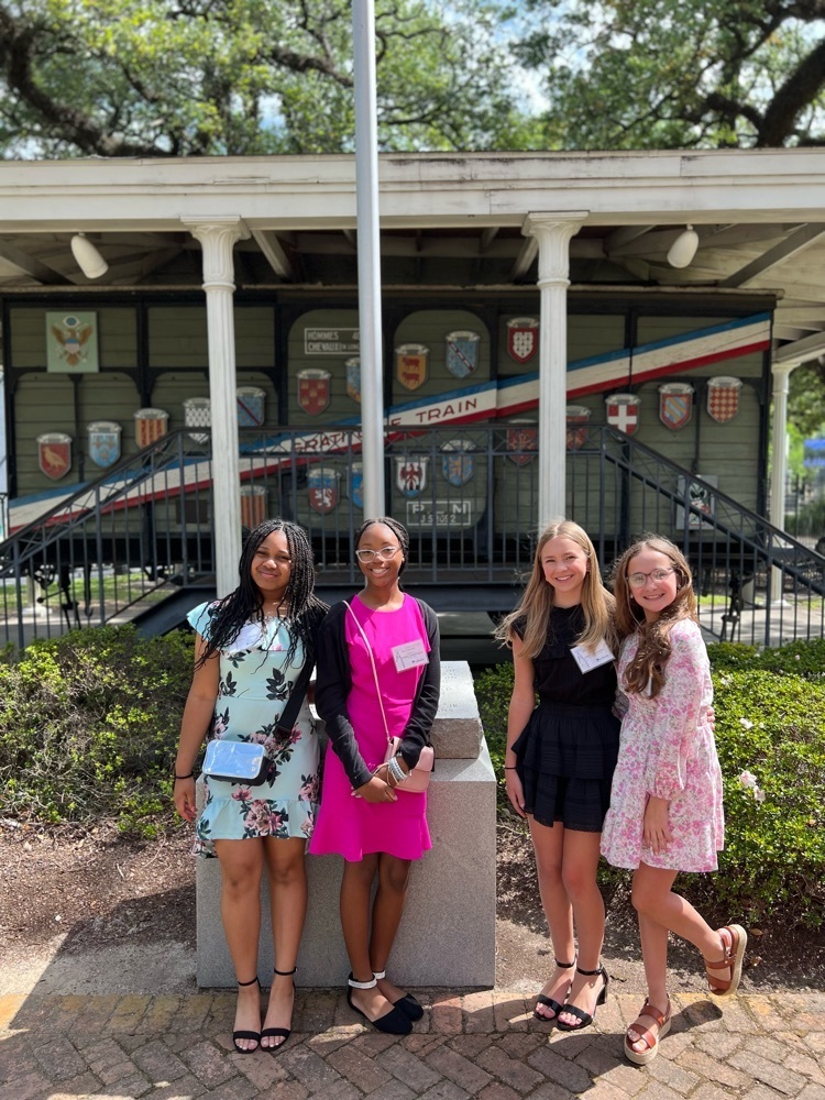 Students pose in front of River Center