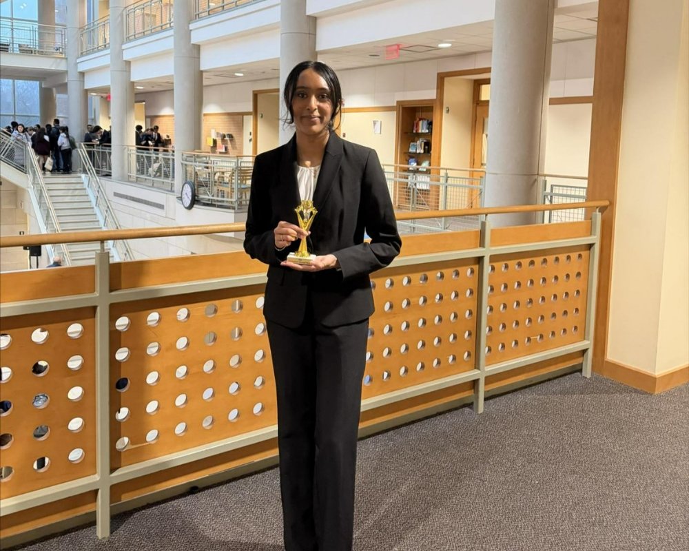 Speech and Debate student with trophy