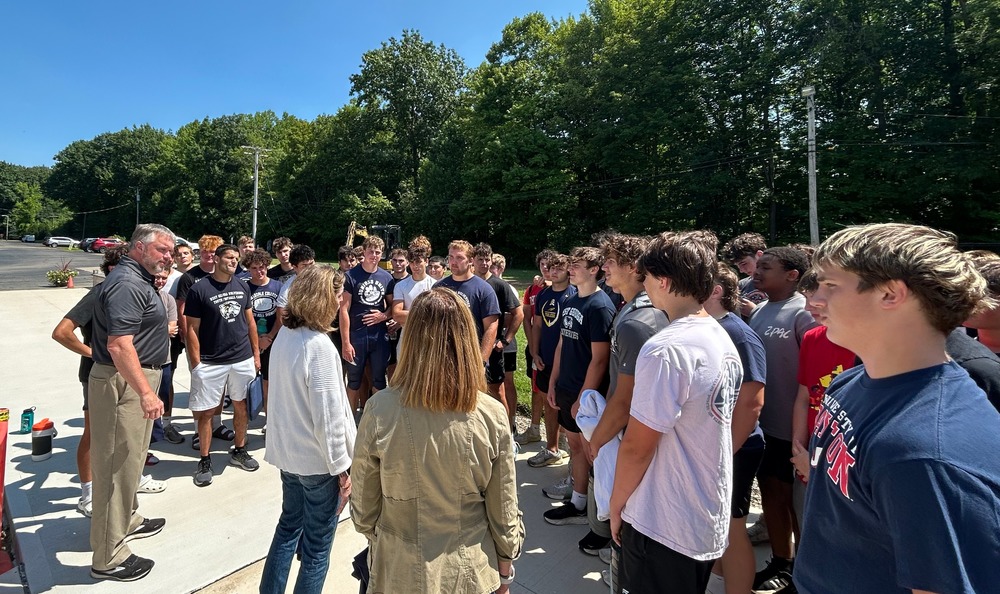 Football team talking to administrators 