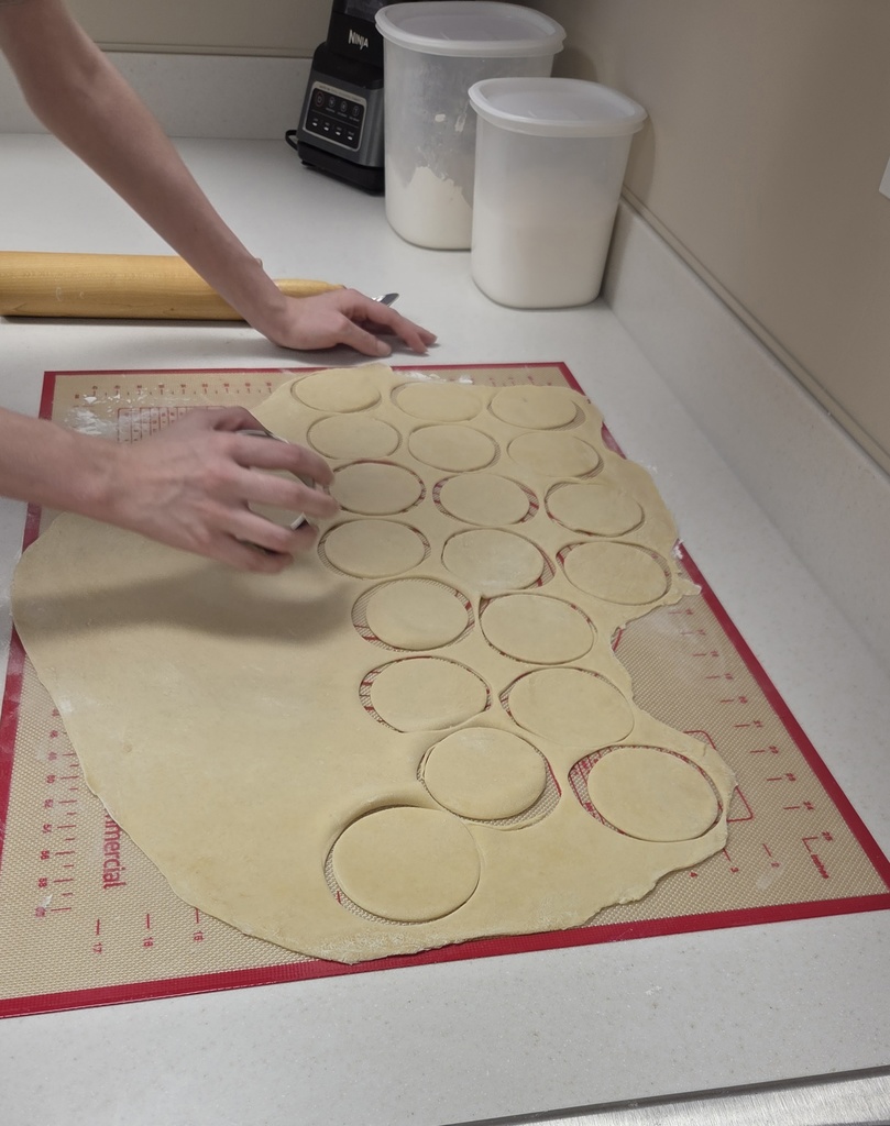 Cutting dough into circles.