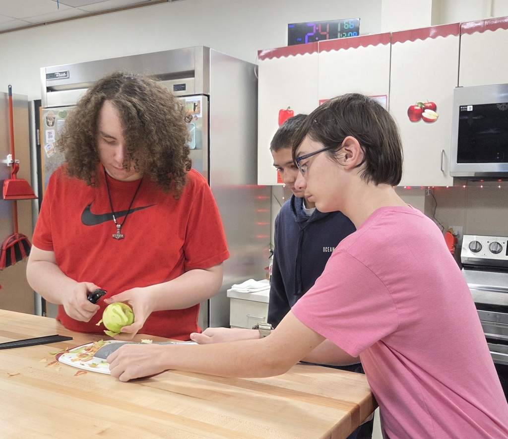 A student peels an apple.