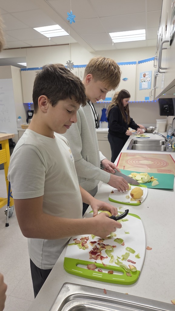 Peeling and slicing  apples on appropriate work surfaces.
