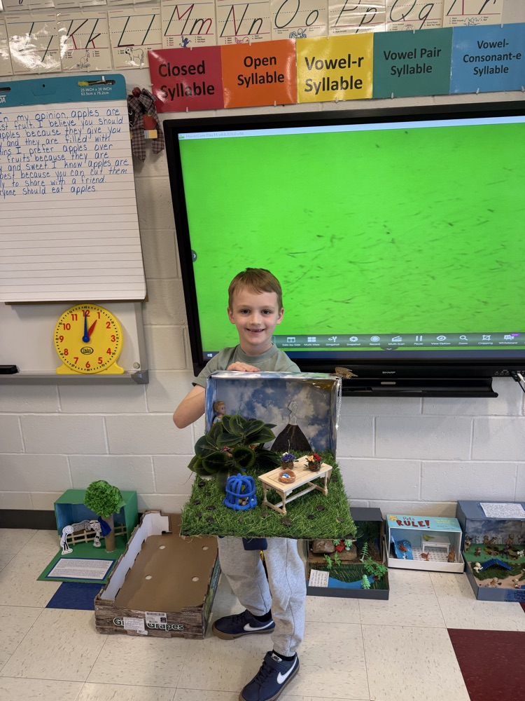 Student showing book project.