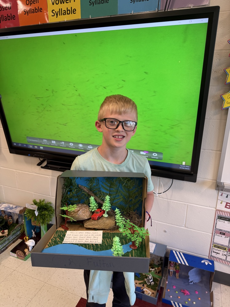 Student showing book project.