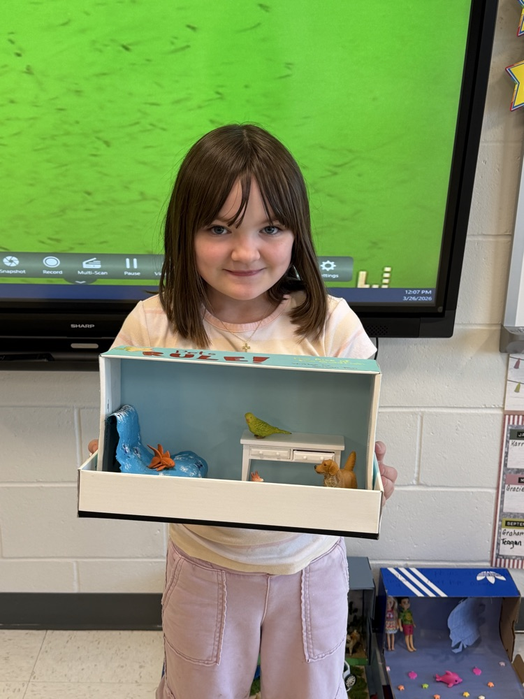 Student showing book project .