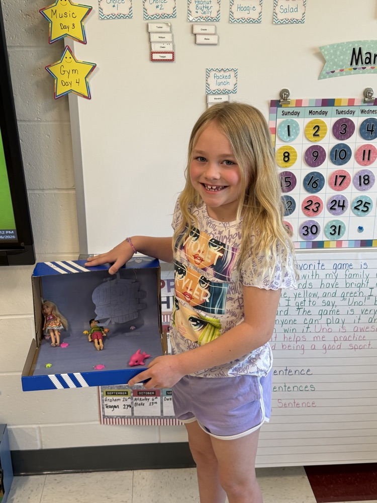 Student showing book project .