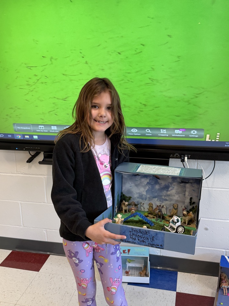 Student showing book project .