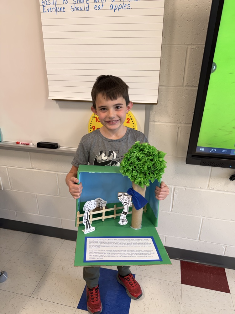 Student showing book project .