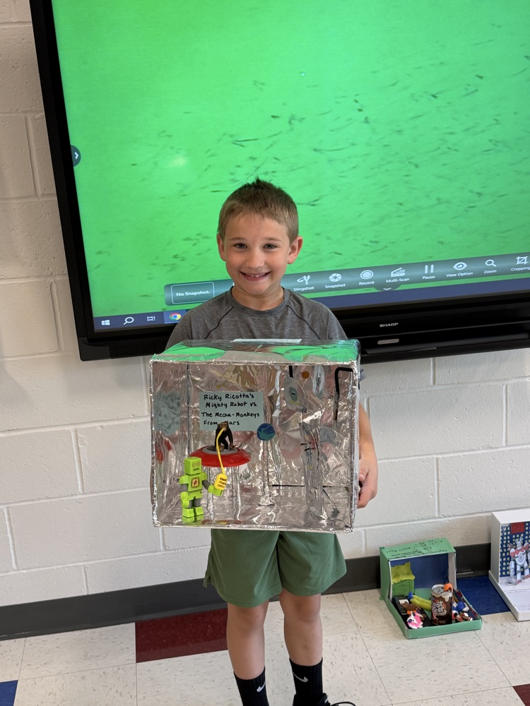 Student showing book project .
