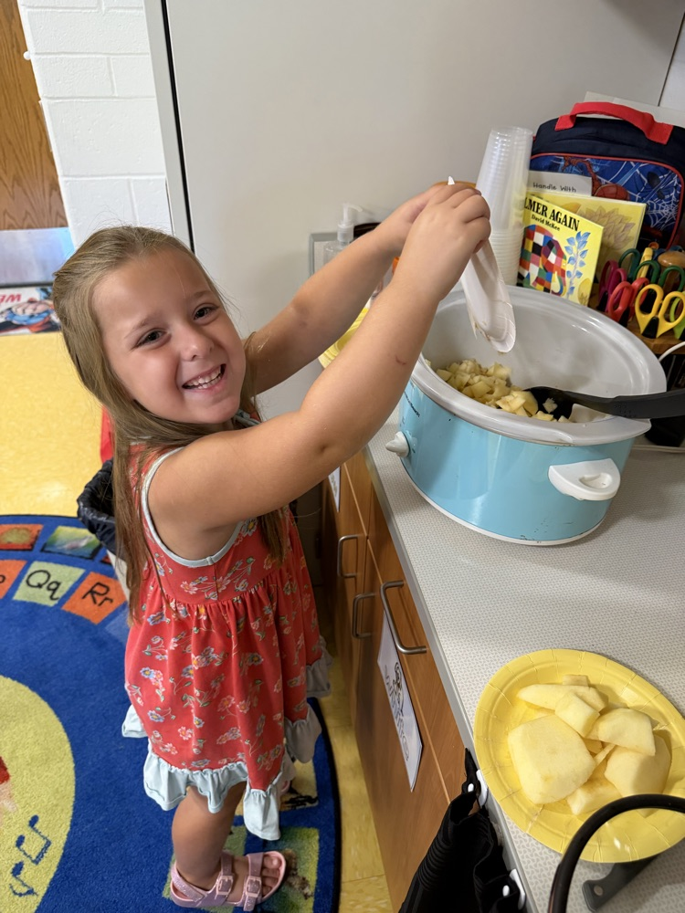   Ella enjoyed making applesauce !