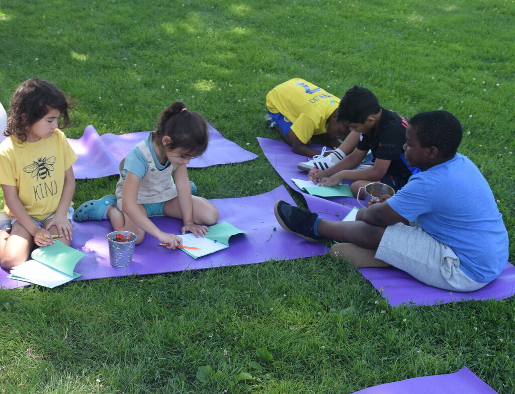 Photo of students journaling their progress outside.