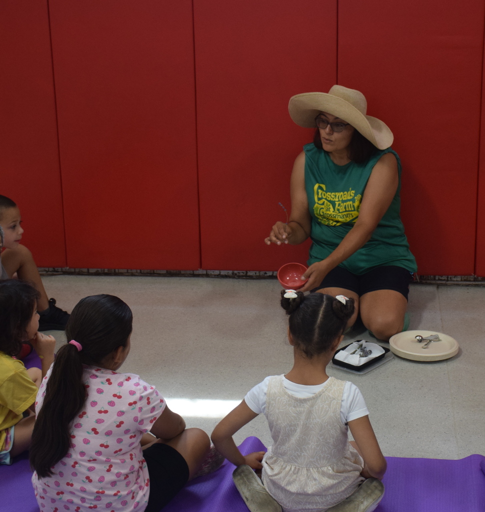 Photo of students listening to garden instructor.