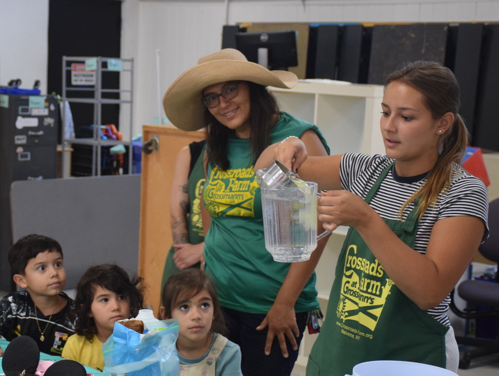 Photo of instructors pouring lemon juice into water.