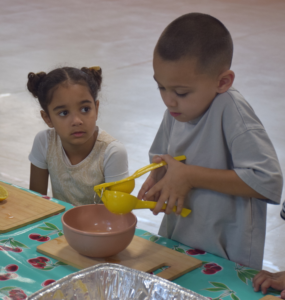 Photo of students squeezing lemonade.