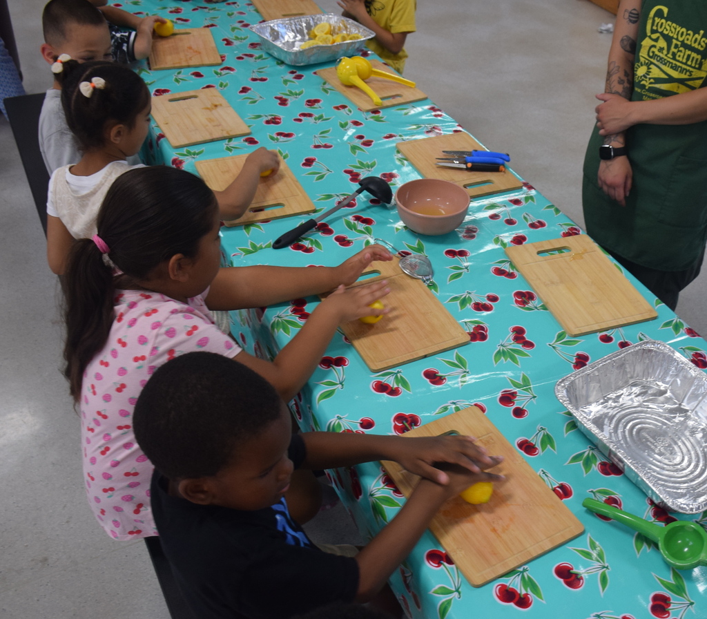 Photo of students squeezing and preparing fresh lemonade.