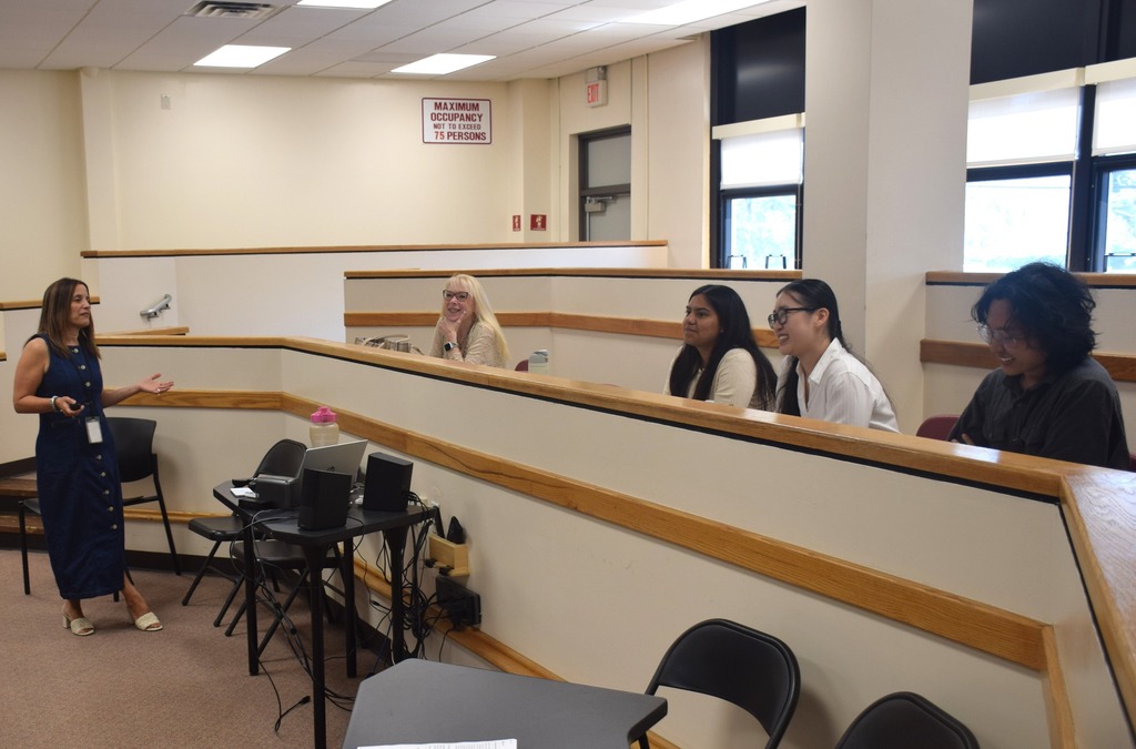 Photo of three Teacher Residency Program scholars sitting with two West Hempstead educators.