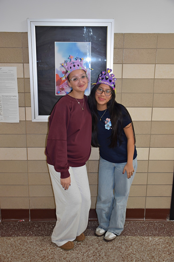 Photo of two high school students wearing pink crowns.