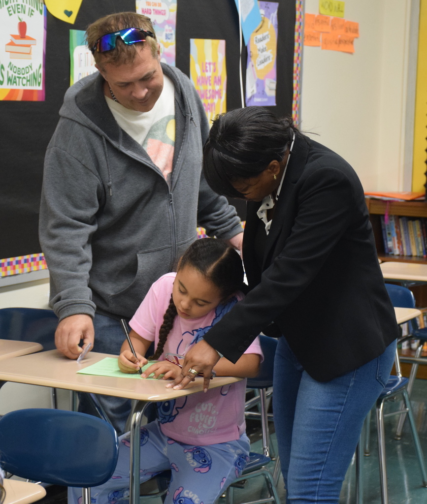 Photo of student working together with parents.