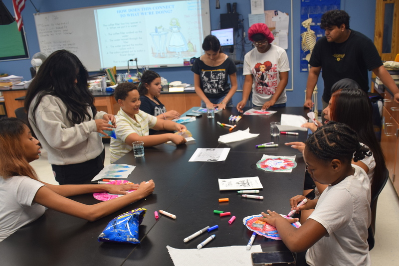 students collaborating in a classroom science experiment
