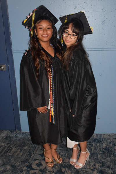 3 graduates in cap and gowns