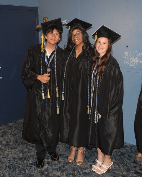 3 graduates in cap and gowns