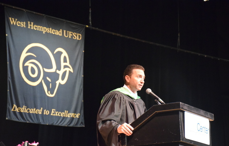 person speaks at podium on stage