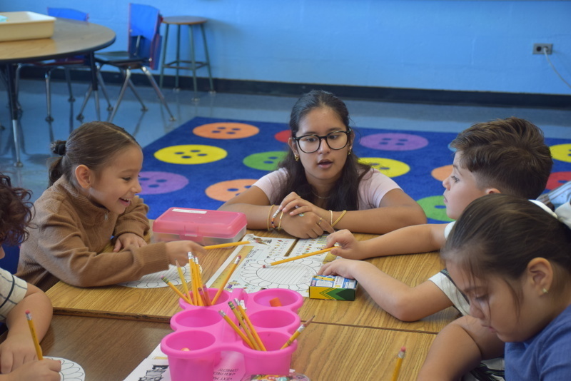 Children coloring at a classroom table