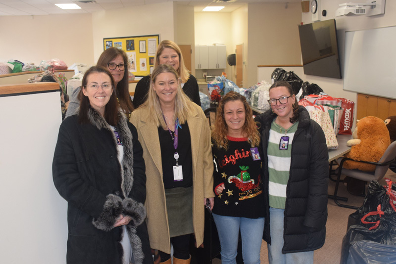 people stand for a group photo in hallway