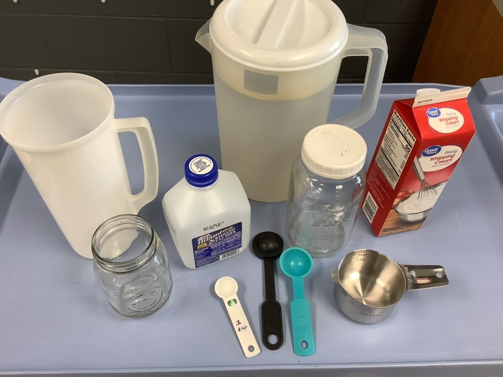 "A mixture of kitchen containers for measuring liquids.