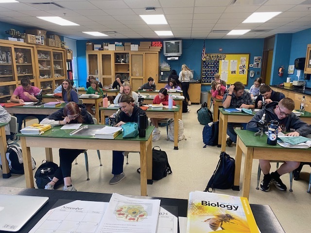 Biology class working with microscopes.